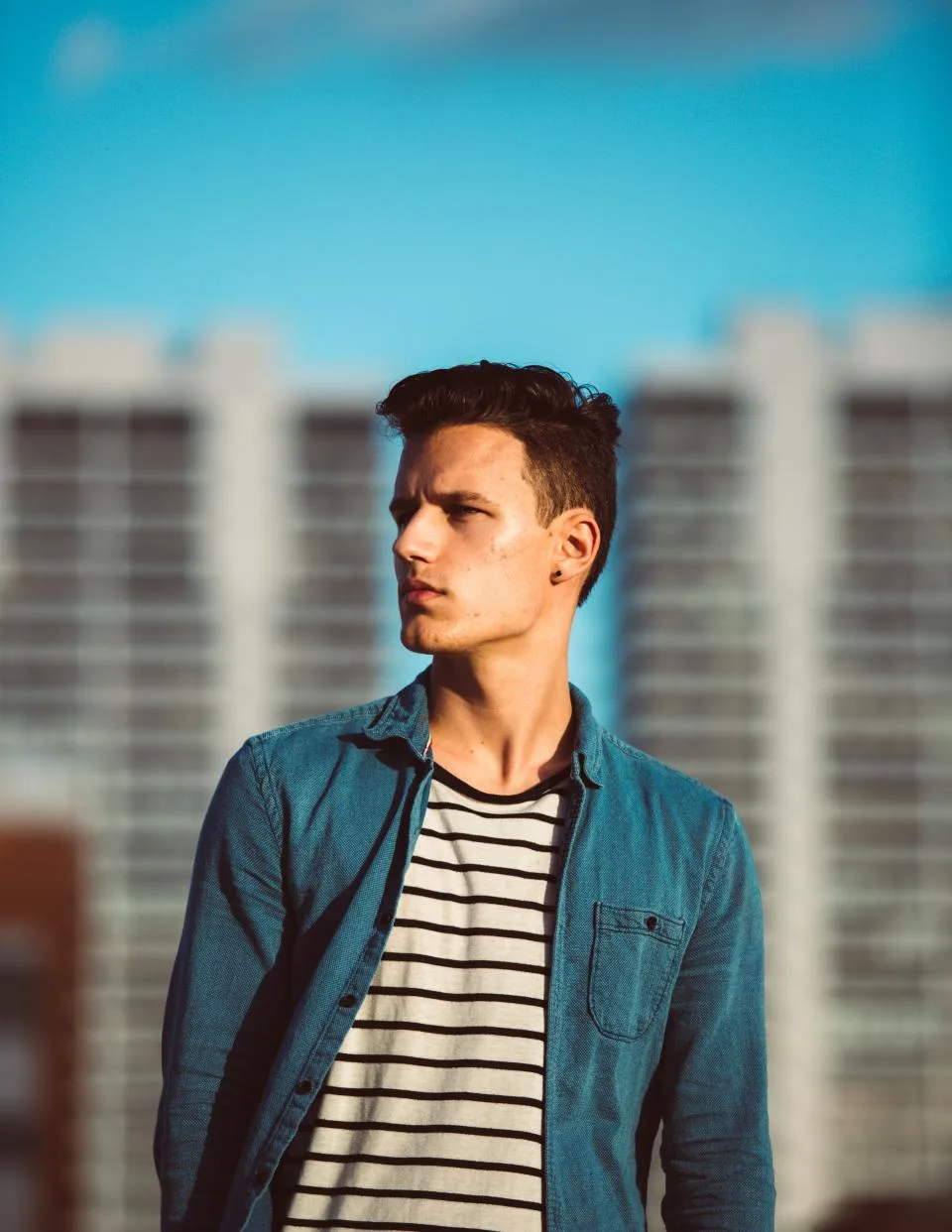 Young man looking away in profile, thinking